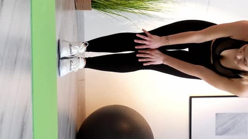 Woman Stretches Legs in Black Sports Clothing