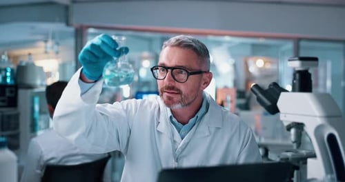 Scientist, mature man and chemical with microscope testing for chemistry, study or medical research