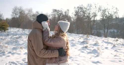 Couple in Love Cuddling in Winter Forest