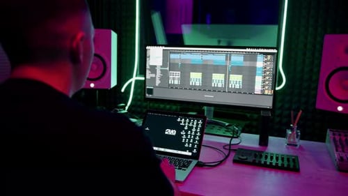 professional sound recording studio sound engineer or music producer sitting at the remote control