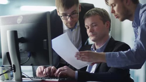 Team of Office Workers Have Discussion Next to Computer