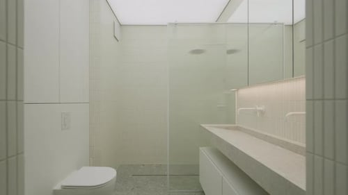 Full bathroom with toilet and luminous ceiling smoothly turning on indoor.