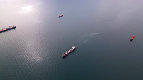 An Aerial Perspective of Cargo Ships Floating on the Open Sea Representing Global Trade and Maritime