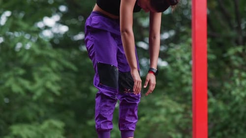 Athletic Woman Stretching in Urban Park