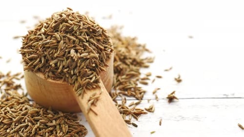 Cumin Seeds on Spoon on Table Close Up
