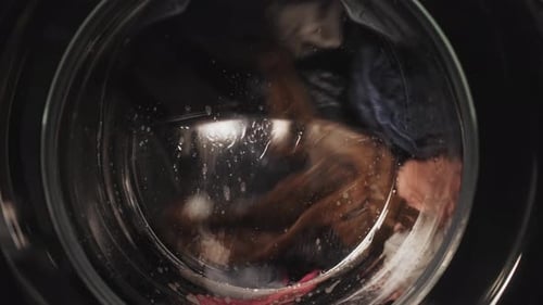 Washing Machine in the Process Wash Clothes in the Washing Machine Closeup of Cleaning Clothes