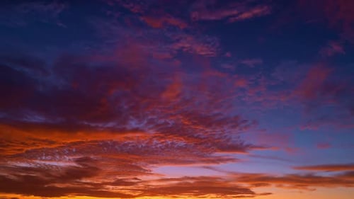 Fiery Clouds Dance Across Vibrant Sunset Sky