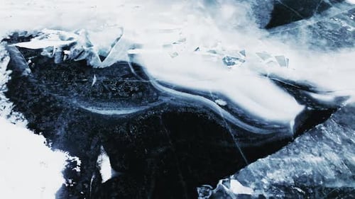 Drone footage gracefully gliding over the frost-kissed surface of Lake Michigan.