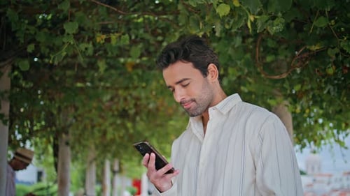 Sexy Brunette Reading Mobile Phone Message Garden Closeup Man Waiting in Park
