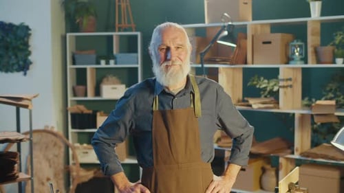 Senior Craftsman Poses in Woodworking Workshop