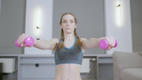 Young Woman Working Out with Hand Weights at Home