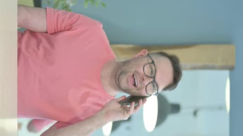 Man Talking on Phone Indoors