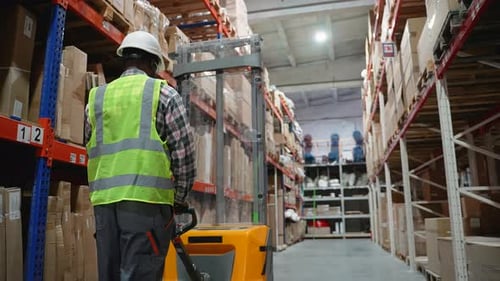 Warehouse Worker Operating Forklift in Storage Facility