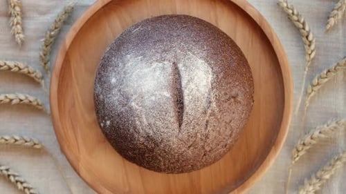 Rustic Loaf of Bread on Wooden Plate