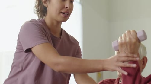 Senior Man Lifting Weights with Assistance