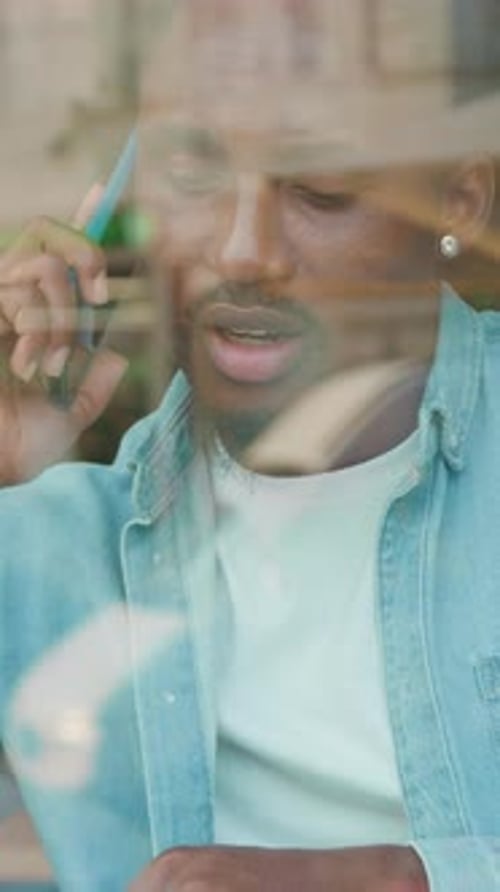 Young Man Talking on Phone in Urban Setting
