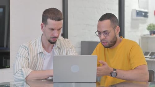 Creative Teammates Working on Laptop in Office