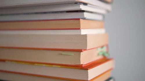 Large close-ups on the edges of books and slow top-to-bottom movement with high depth of field. Book