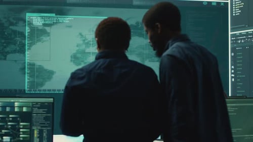 Tech Workers Collaborating on Code in Bright Office