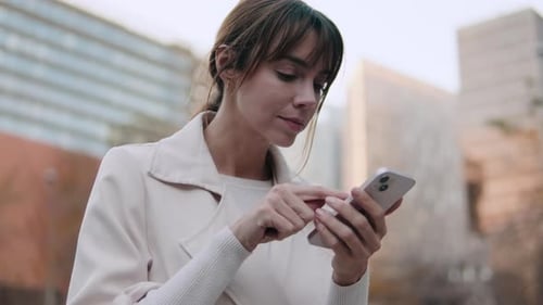 Close up of the Businesswoman Using Smartphone on City Street