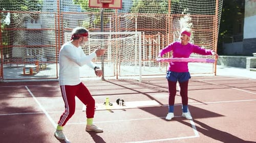 Elderly Fitness Enthusiasts Enjoying Exercising Together in the Park for Their Wellbeing