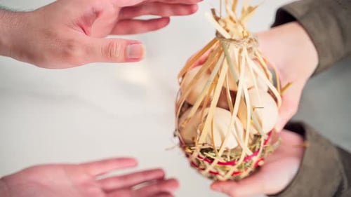 Top view man hands received basket of eggs gift from girl hand