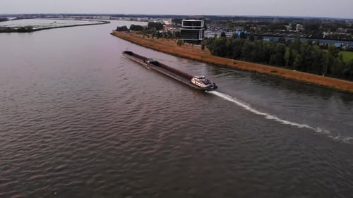 Pull Back Shot Of Large Candesso Cargo Ship Sailing In Noord River, Alblasserdam south Holland