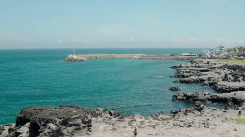 Drone landscape of magnificent volcanic rocks and blue sea. jeju island.