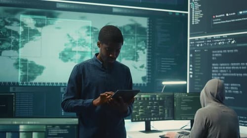Man Works on Tablet in a Tech Office
