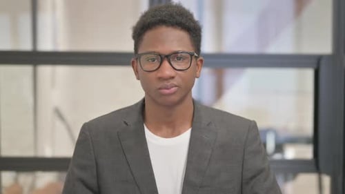 Young Adult Portrait with Glasses in Office Setting