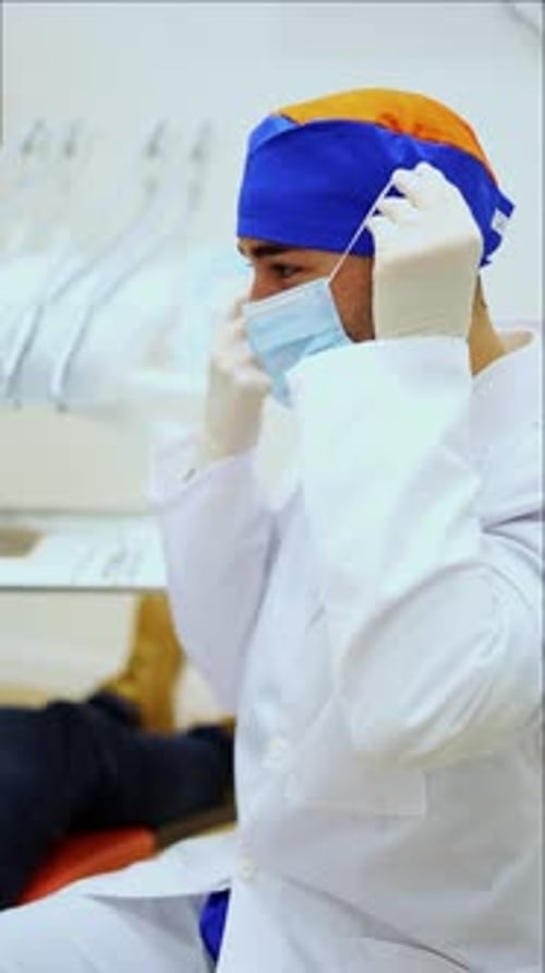 vertical Dentist wearing surgical mask getting ready for surgery