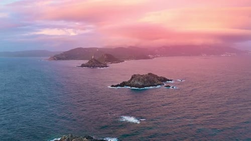 Stunning sunset over the rocky coastline of a serene island paradise