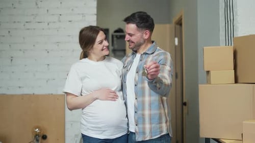 close up of the hands happy married couple holding keys to a new apartment. family bought a house