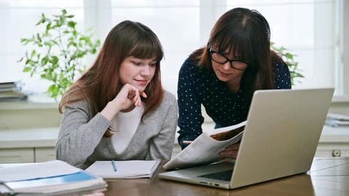 Teenager Studying with Adult Supervision at Home