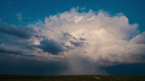 Storm Clouds and Sunlight over Rolling Fields