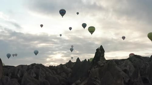 Aerial video of hot air balloons at sunrise, iconic destination behind Cappadocia Turkey