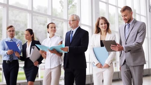 Business Team Walking Together with Documents and Tablet