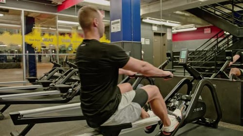 Man Train on Sports Training Equipment in a Fitness Gym