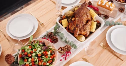 Holiday Meal on Wood Table with Turkey and Vegetables
