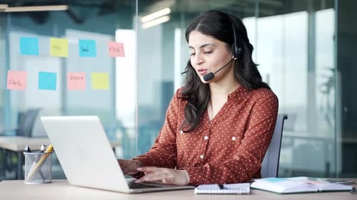 Young Woman Using Laptop in Modern Office Environment