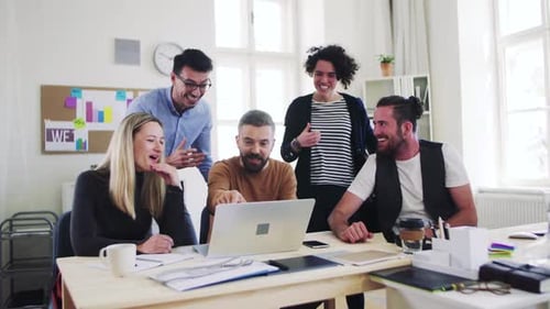 Young business team celebrates success together in a modern office space