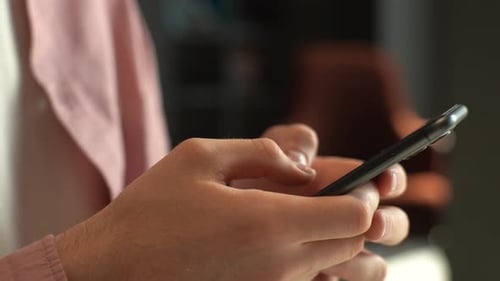 Close up of Hands Typing on a Smartphone