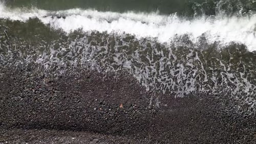 Top down aerial drone view of rocky beach