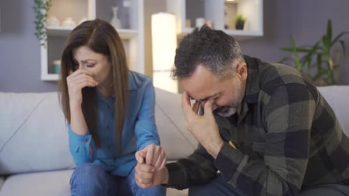 Couple Comforting Each Other at Home, Difficult Times