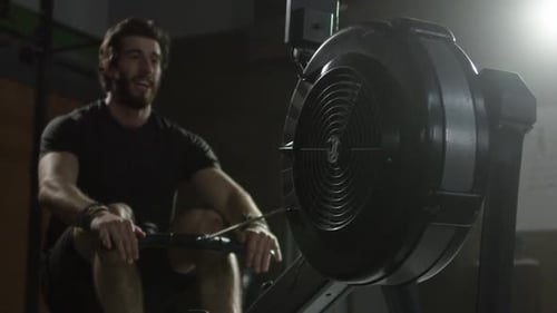 Extreme Atheltics - Male athlete close up rowing machine