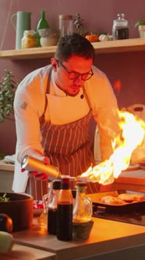 Chef Charring Food in Kitchen with Blowtorch