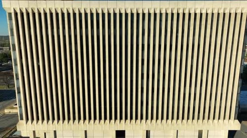 Nondescript government building in USA during golden hour light. Offices in concrete tower.