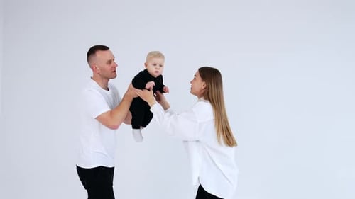 Loving Family With Baby in White Studio