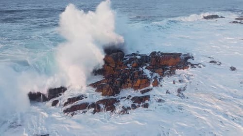 Stunning Dynamic Ocean Waves Powerfully Crashing on Rocky Shore Along the Beautiful Coastline