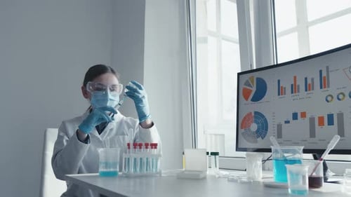 A Scientist is Conducting Laboratory Research Using Test Tubes and Analyzing Data The Research